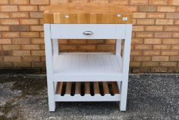 A contemporary kitchen island butchers block with single drawer,