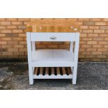 A contemporary kitchen island butchers block with single drawer,