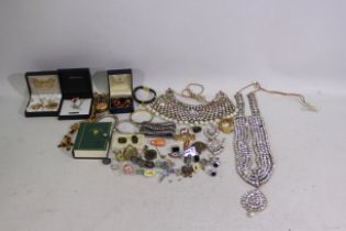 A collection of costume jewellery, cuffl