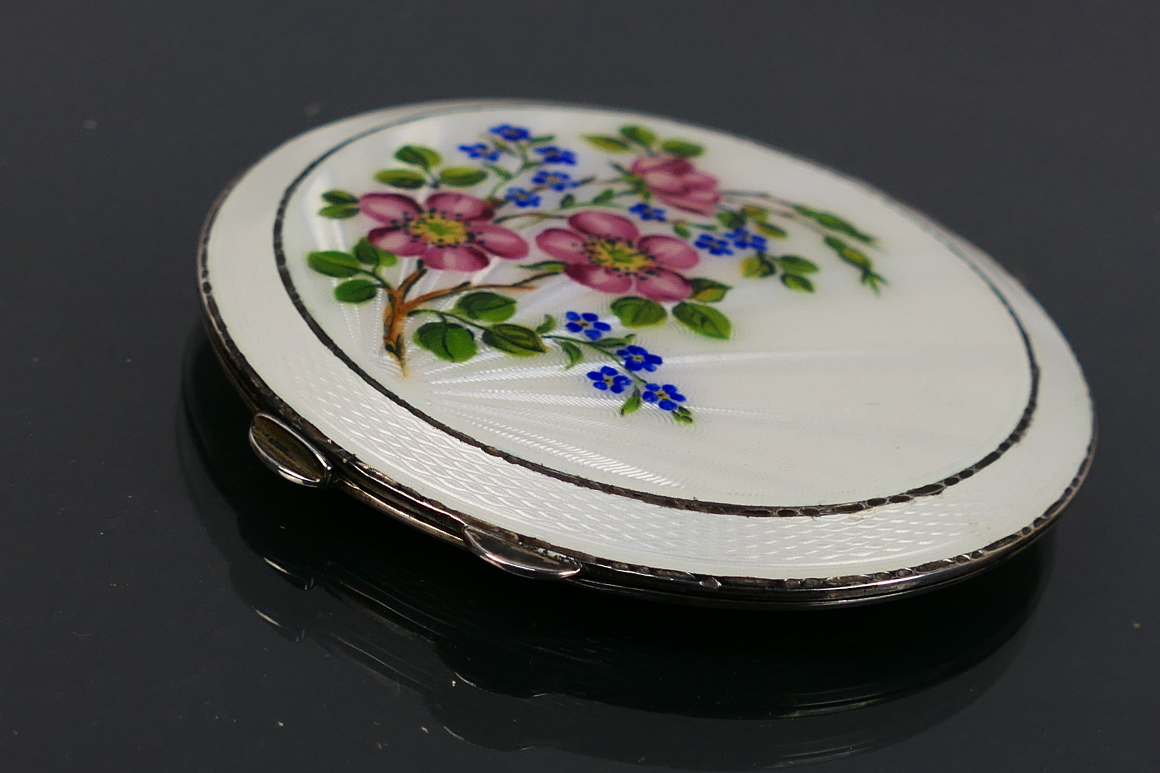 Henry Clifford Davis - A guilloche enameled powder compact with a floral display on the white - Image 3 of 10