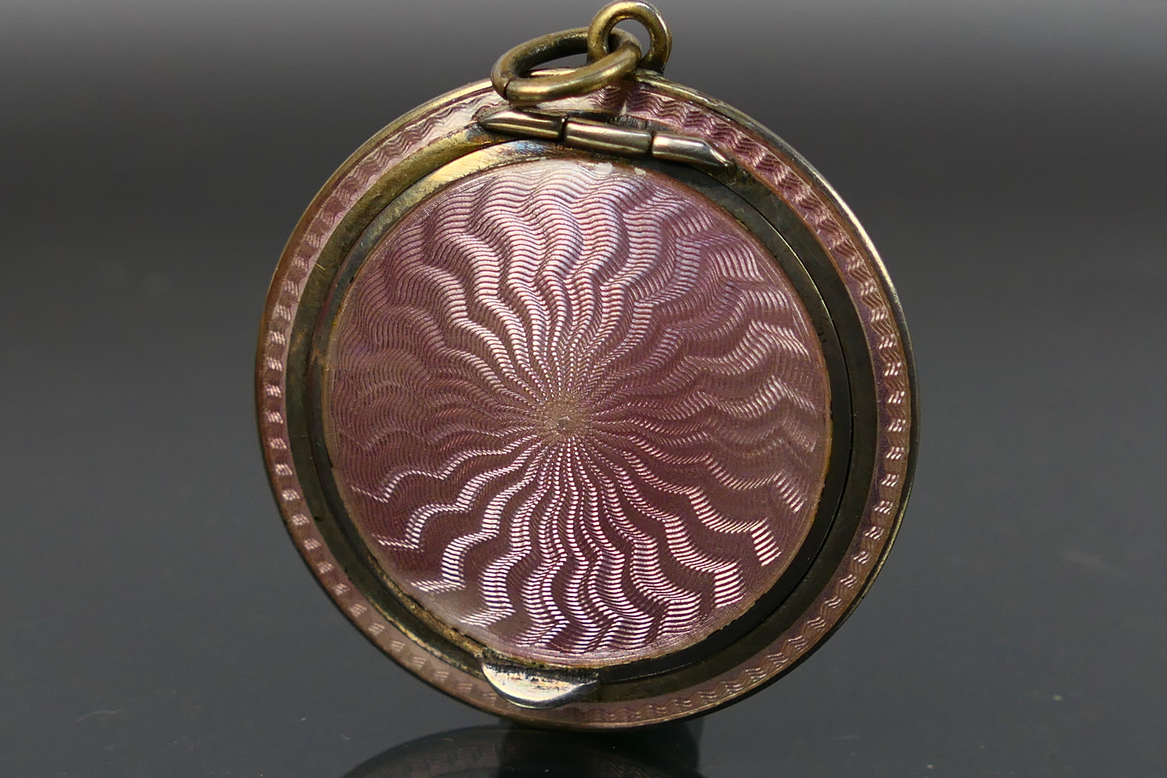 A miniature guilloche enamel powder compact, covered front and back in pale pink enamel. - Image 2 of 6