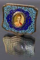 A continental gilt metal compact with oval portrait of a lady and blue enamel decoration to the lid.