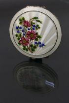 Henry Clifford Davis - A guilloche enameled powder compact with a floral display on the white