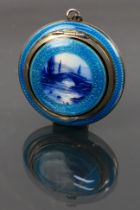 A continental guilloche enamel miniature compact with a picture of a bridge on the lid and a