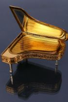 A vintage 1950s Pygmalion Sonata powder compact. Numbered #21. Made in England. Foldable piano legs.