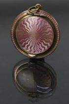 A miniature guilloche enamel powder compact, covered front and back in pale pink enamel.