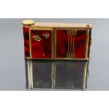 An art deco style German made musical compact, lipstick and cigarette case in the form of a camera.