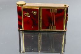 An art deco style German made musical compact, lipstick and cigarette case in the form of a camera.