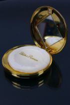 Paloma Picasso - A vintage gold coloured Paloma Picasso refillable powder compact with original