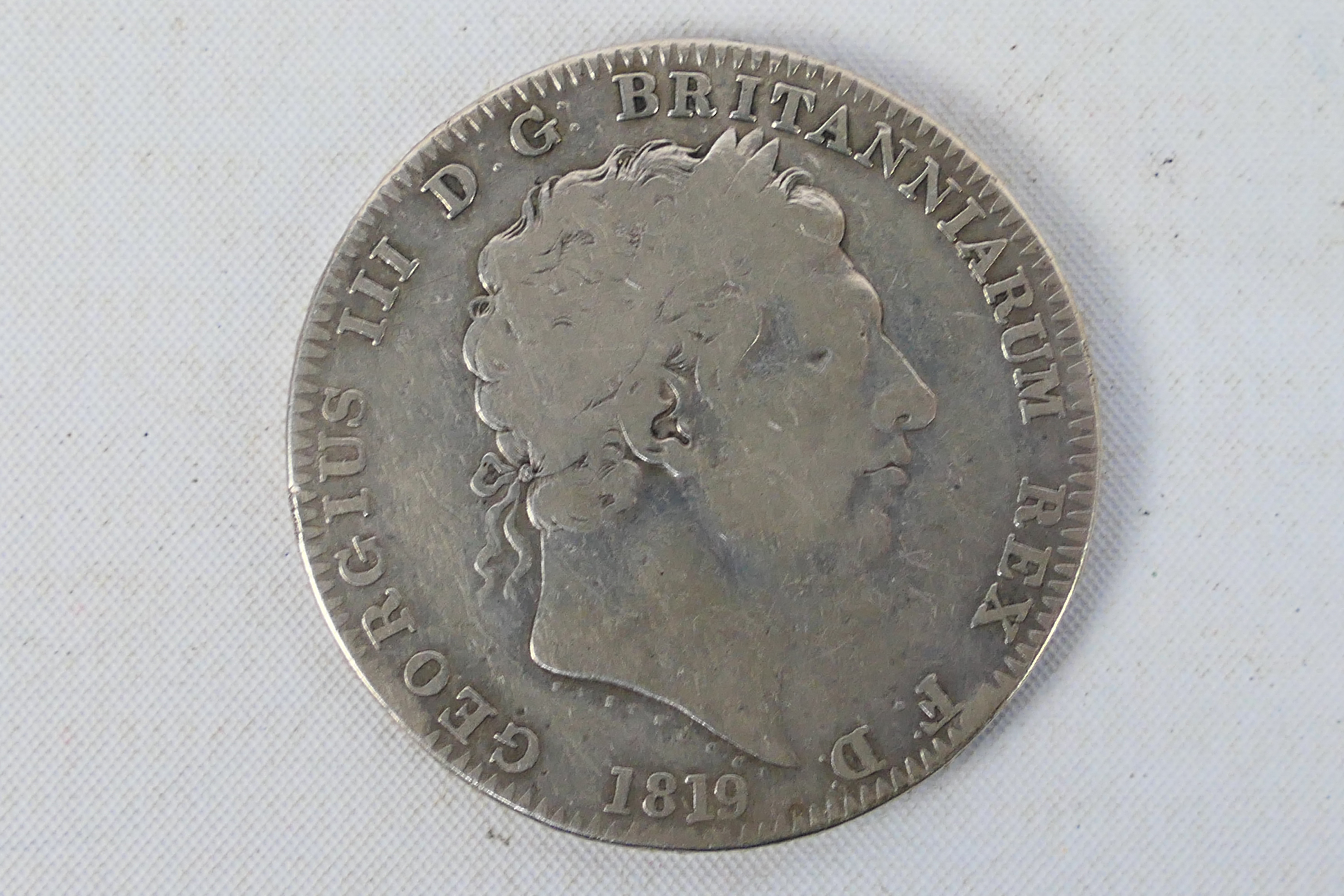 A George III silver crown, 1819. [W]
