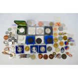 A collection of various coins, medals, c