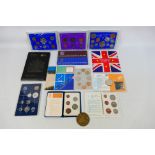 A collection of coin sets and similar to