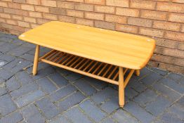 An Ercol style coffee table with spindle undertier, approximately 37 cm x 104 cm x 49 cm.