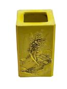 Chinese yellow ground square form brush pot decorated with raised tree and village and verse scenes,