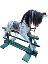 Sponge painted rocking horse on painted safety stand, 131cm by 143cm.
