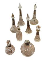 Eight silver mounted glass scent bottles.