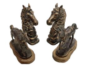 Pair of bronzed horses heads and pair of bronzed horses on wood plinths.