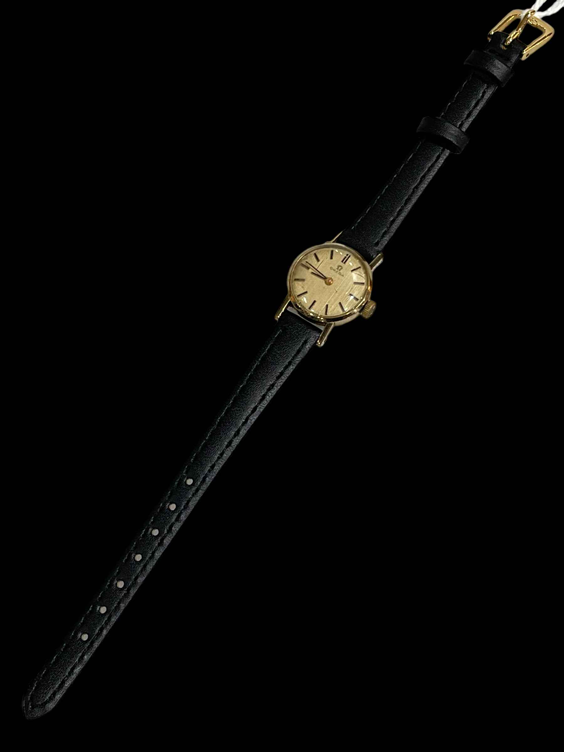 Ladies Omega gold wristwatch with leather strap.