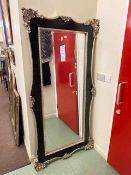 Rectangular black and silvered framed bevelled wall mirror, 183cm by 90cm including frame.