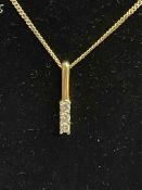 Diamond three stone 18 carat gold pendant with 9 carat gold chain.