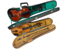 Two violins in cases with bows.