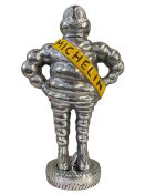 Small chromed model of The Michelin Man.