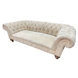 Chesterfield settee in deep buttoned light gold fabric.