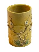 Chinese yellow glaze brush pot with raised floral pattern, impressed seal mark to base, 10.5cm.