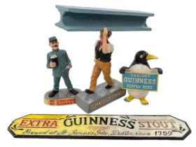 Cast metal Guinness sign and three Guinness advert figures.
