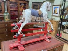 Small sponge painted rocking horse on safety stand, 97cm by 112cm.