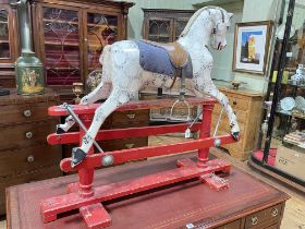 Small sponge painted rocking horse on safety stand, 97cm by 112cm.