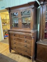 Victorian mahogany press having two glazed panel doors above a base of six drawers,