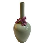 Chinese green glazed bottle neck vase with applied pink dragon decoration, blue seal mark to base,
