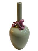 Chinese green glazed bottle neck vase with applied pink dragon decoration, blue seal mark to base,