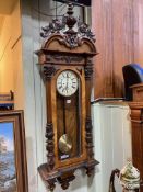 Victorian walnut cased double weight Vienna wall clock having enamelled dial.