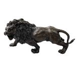 Bronze model of a lion, 32cm long.