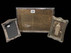 Three silver easel photograph frames, two shaped, one rectangular.