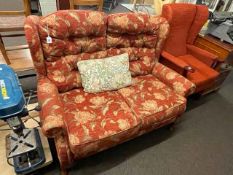 Two seater settee in floral pattern fabric and wing armchair.