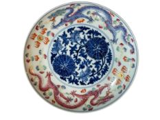 Chinese porcelain plate decorated with mythical dragons and blue and white floral design to front