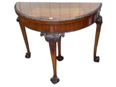 Mahogany Chippendale style demi lune fold top card table on ball and claw legs, 75cm by 91.