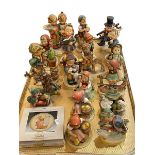 Nineteen Hummel figures and boxed collectors plate.