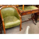 Green leather occasional armchair and mahogany two drawer sofa table (2).