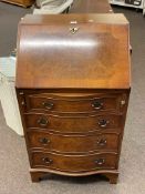 Bevan & Funnell Reprodux burr walnut four drawer serpentine front bureau, 85cm by 53.5cm by 41cm.