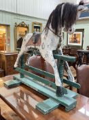Sponge painted rocking horse on painted safety stand, 131cm by 143cm.