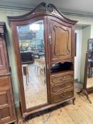 Late 19th/early 20th Century mahogany combination wardrobe having mirror door flanked by a cupboard
