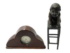 Small bronze of a child kneeling on a stool and mahogany propeller clock.