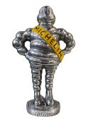 Small chromed model of the Michelin Man.