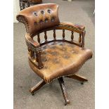 Tan buttoned leather Captains style swivel desk chair.