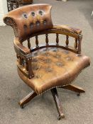 Tan buttoned leather Captains style swivel desk chair.