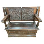 Carved oak Monks bench, 79.5cm by 122cm by 50cm (closed).